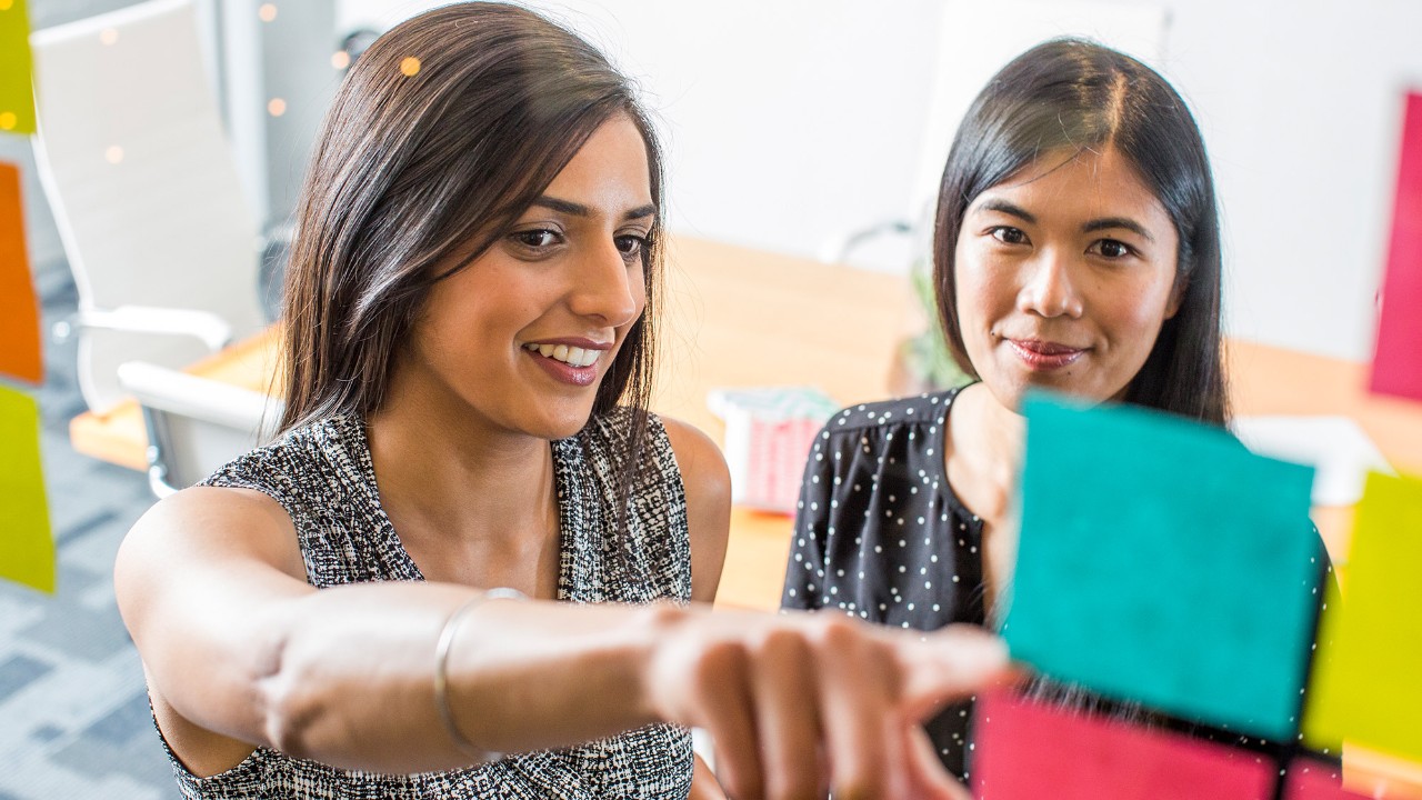 two women checking on post-it; image used for complaints and feedback page